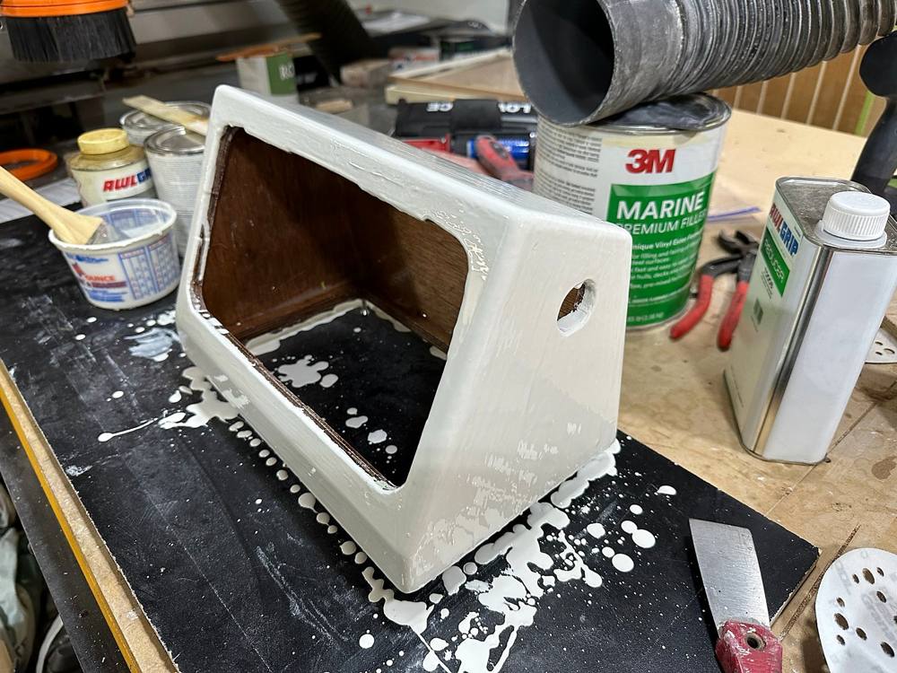 A chartplotter pod on the shop bench after glassing and fairing